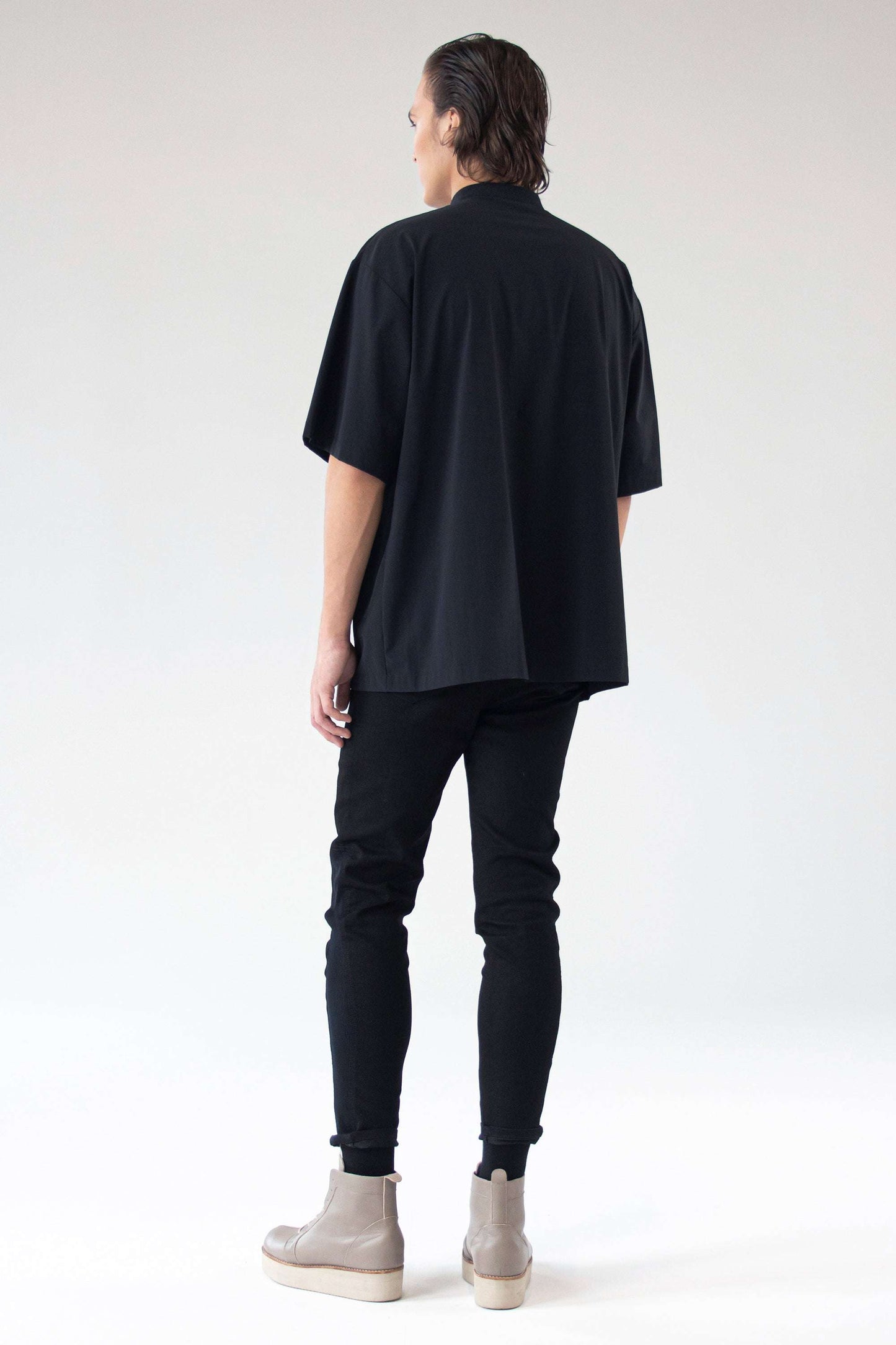 Model wearing oversized shirt Holy, back view