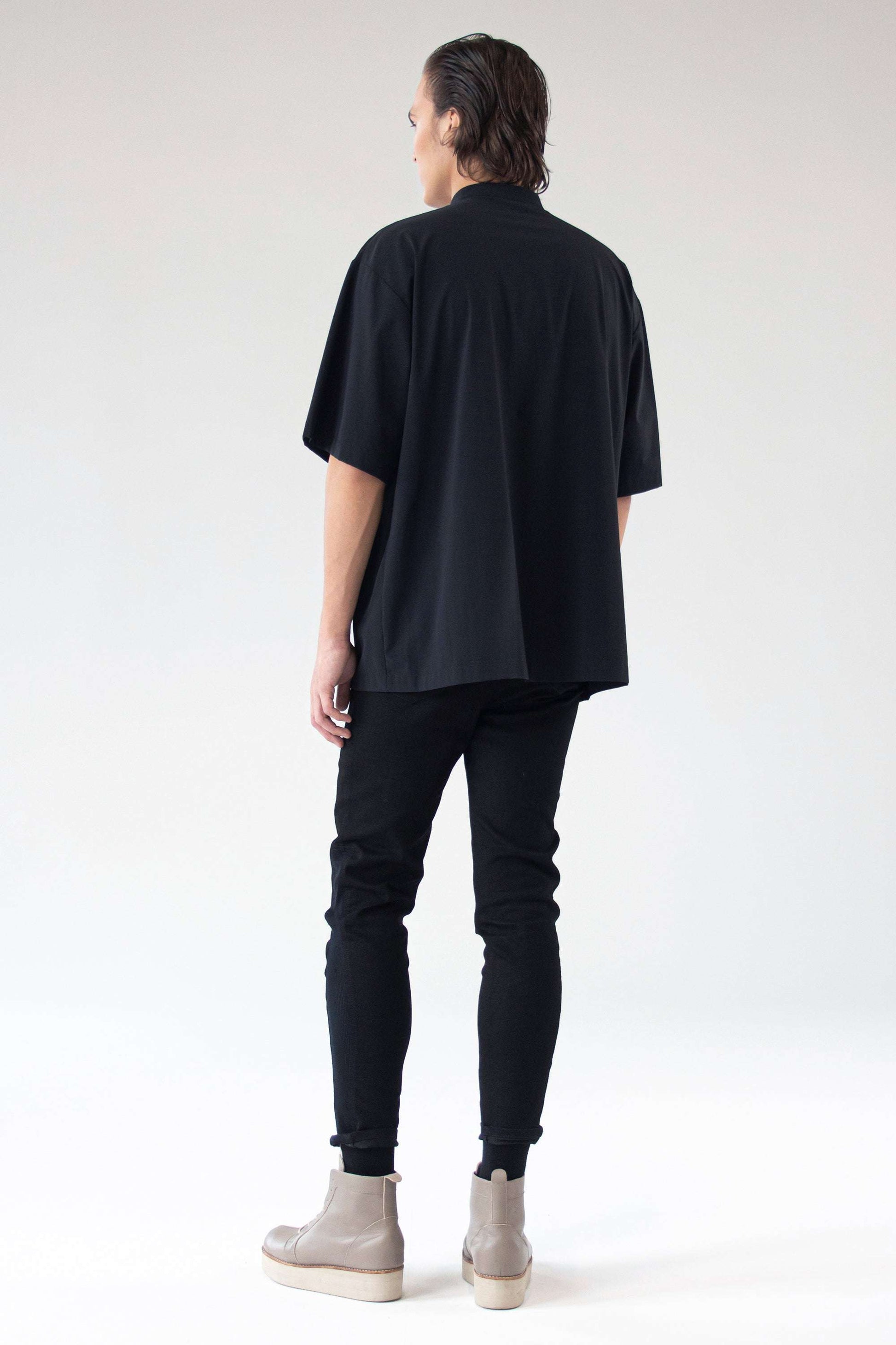 Model wearing oversized shirt Holy, back view